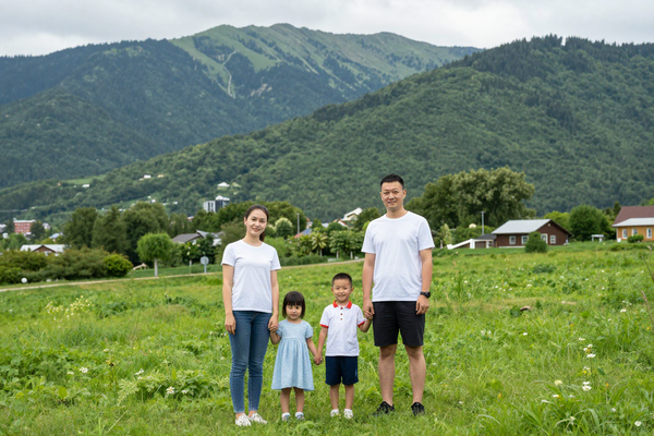 Russian family on vacation in Kislovodsk park, green valley, mountains in background